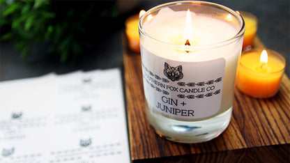 Rounded corner white vinyl sheet labels applied to a clear candle jar